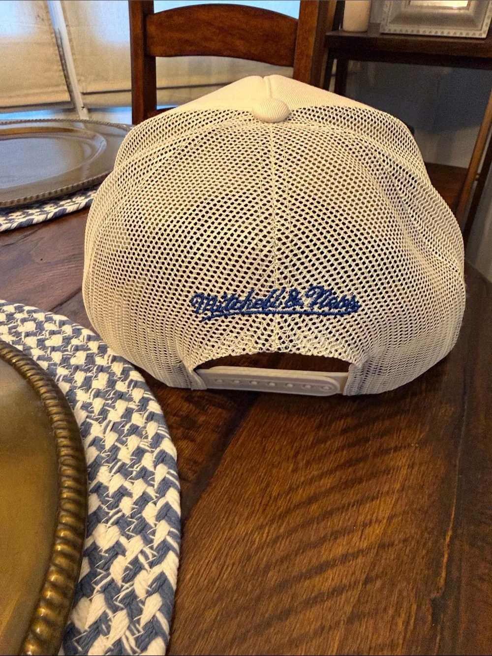 Mitchell & Ness Cream Trucker Hat with Blue and Yellow Bear Logo.